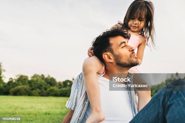 Image Of Happy Cute Little Girl Playing With Father In The Park During The Sunset Handsome Dad Is Spending Time With His Little Cheerful Daughter Outdoors Fathers Day Daddy And Daughter Shares Love Stock Photo - Download Image Now