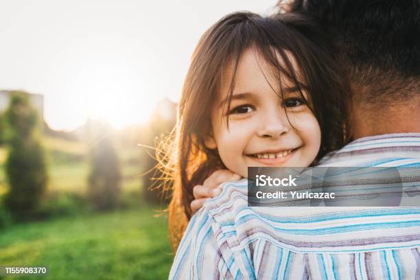 Closeup Image Of Happy Daughter Embraces Her Dad Feels Joyful Happy Cute Little Girl Playing With Father In The Park Smiling And Looking To The Camera Fathers Day Daddy And Daughter Shares Love Stock Photo - Download Image Now