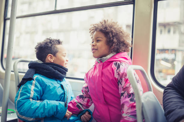 istock Young siblings, sister and brother in public transportation 1155908646