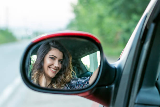 istock Attractive Woman in Rearview Mirror 1155908817