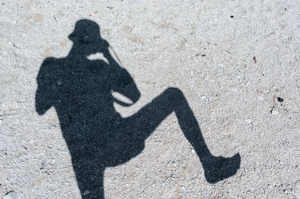 istock Silhouette shadow of photographer on stony ground 1155909792