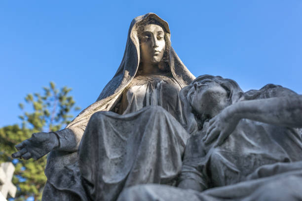 istock Tomstone statue with mourning ladies at cemetery 1155910066