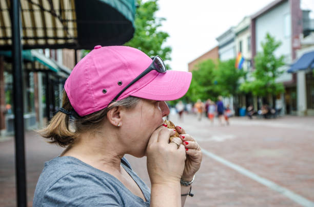 istock Woman eating sandwich 1155910485