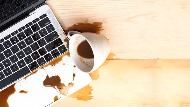 Photo of Coffee spilled into a computer notebook