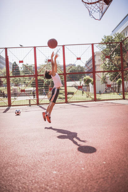istock Cute little-mixed race boy, playing basketball 1155911136