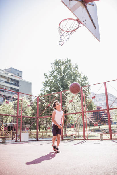 istock Cute little-mixed race boy, playing basketball 1155911221