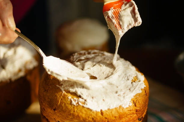 istock Coating a homemade cake in white icing by a culinary brush close up 1155911911