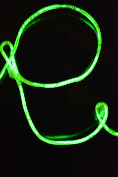 istock Lime green lighting with a specific pattern. Woven filaments, cable, wires with outgoing light. Neon electroluminescent wire with an inscription and letters open. 1155912870
