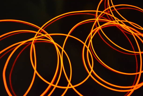 istock Glowing red material, thin bright threads. Burning wire, beautiful textural drawing of light. Art abstraction light fiber, tangle lines and abstraction. 1155912958