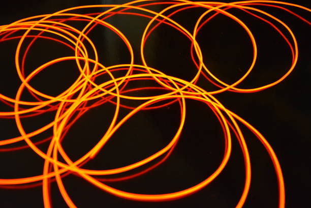 istock Glowing red material, thin bright threads. Burning wire, beautiful textural drawing of light. Art abstraction light fiber, tangle lines and abstraction. 1155912961