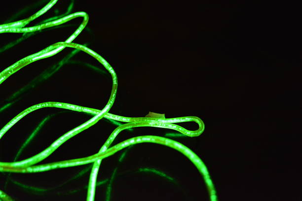 istock Toxic green lime lighting with a specific pattern. Woven filaments, cable, wires with outgoing light. Neon electroluminescent wire in the form of night lighting. 1155913223