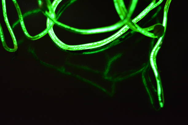 istock Toxic green lime lighting with a specific pattern. Woven filaments, cable, wires with outgoing light. Neon electroluminescent wire in the form of night lighting. 1155913233
