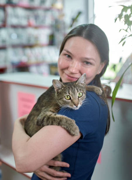 istock Cheerful Young Woman With Her Cat In Veterinary Office 1155917713