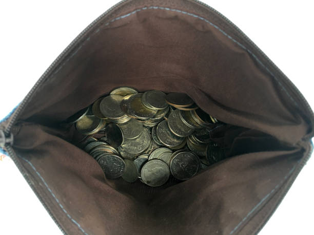 istock Coins inside brown bag for saving or business concept isolated on white background. 1155918833
