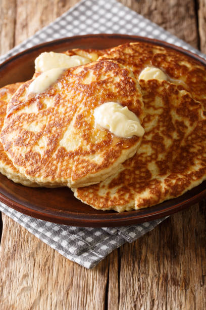 istock Delicious Sweet Griddle Cakes with butter close-up on a plate. vertical 1155919193