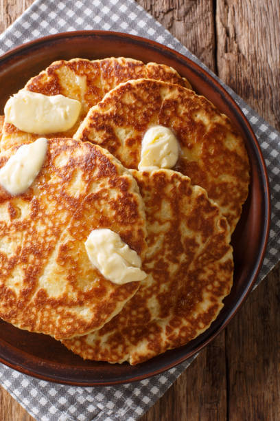 istock Delicious grilled pancakes with butter close-up on a plate. Vertical top view 1155919216