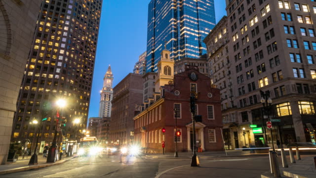 4K Time lapse of crowned people and traffic in front area of Boston old state house at the twilight time, Massachusetts, USA downtown skyline, Architecture and building with tourist concept