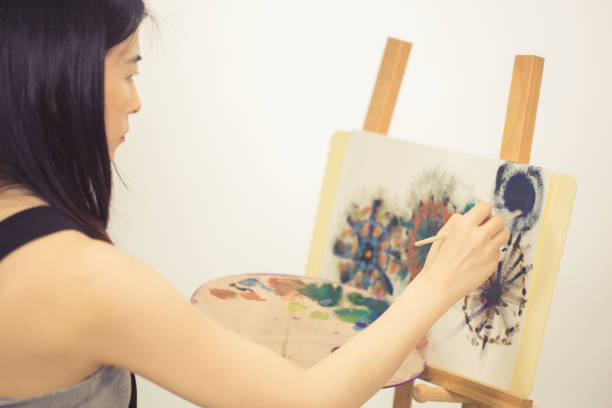 istock Artist painting on an easel 1155921587