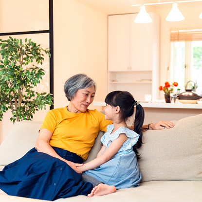 A grandmother and her granddaughter enjoying each other's company at home.