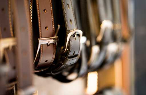 Leather belts in a store.
