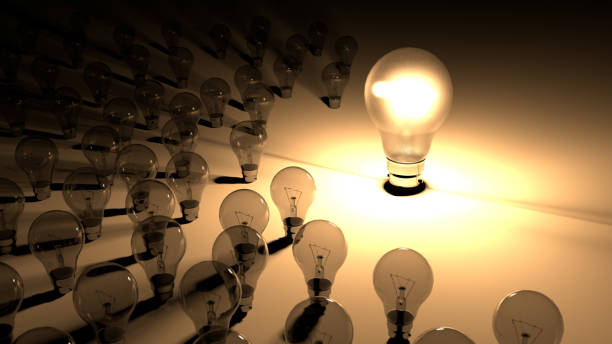 istock Lightbulbs placed around the glowing light bulb. The big lighbulb is glowing surounded by small lightbulbs, which are dead and shutdown. Representation of big energy consuption of bulbs. 1155924185
