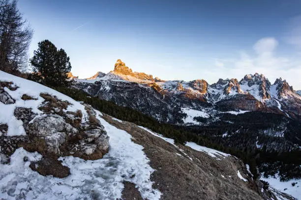 Photo of wonderful fisheye view of scenic snowy landscape in italian dolomites in sunset, peak tre cime di lavaredo in the back