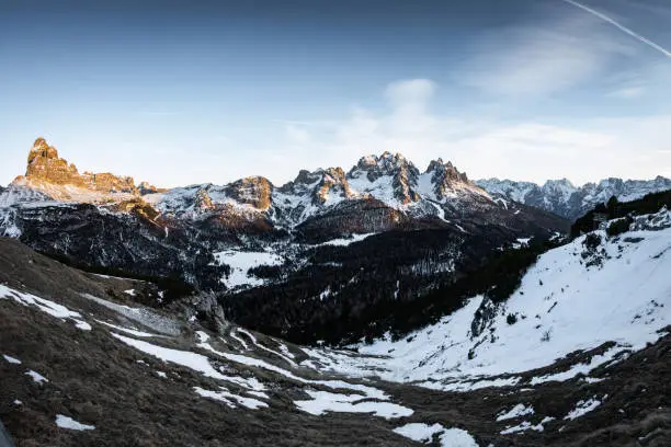 Photo of wonderful fisheye view of scenic snowy landscape in italian dolomites in sunset, peak tre cime di lavaredo in the back