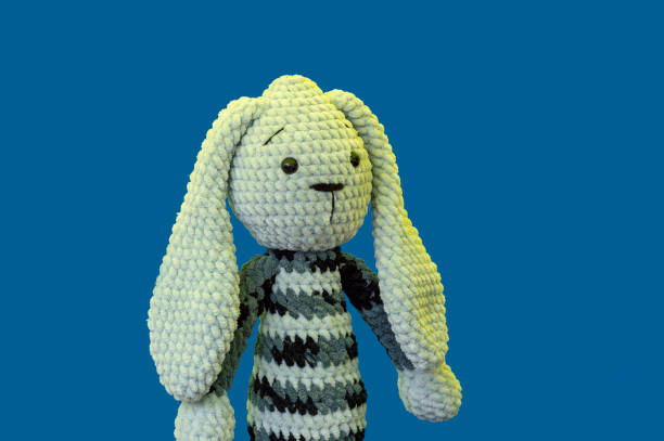 istock Plush hare doll on a blue background at the fair 1155926936