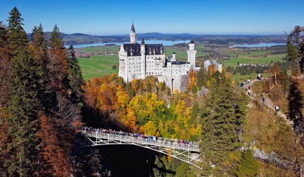 Fussen, Germany - March 15, 2015: Neuschwanstein, beautiful fairytale castle near Munich in Bavaria, Germany, with colorful trees.
