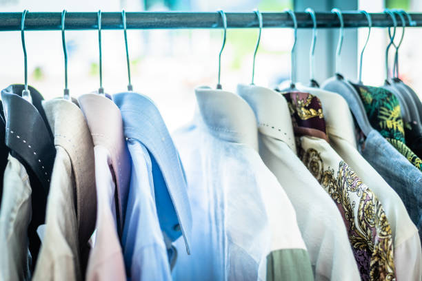 istock Summer wardrobe showcase. White and gray tone knitwear hanging on a coat rack. Selective focus, horizontal 1155928111