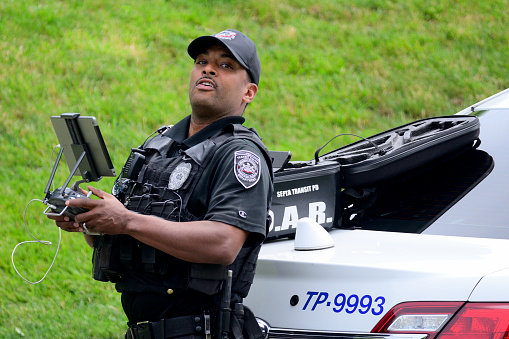 An officer of the SEPTA Transit Police operates a surveillance drone during an unsuccsfull attempt to find and capture a black bear roaming Northwest Philadelphia, PA on June 12, 2019. While rare inside the city limits it is not unusual in this time of the year as young bears start to migrate after being pushed away by their mothers.
