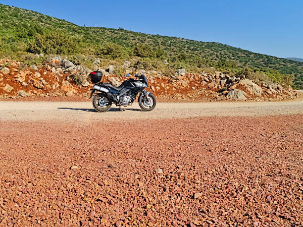 suzuki dl650 (v-strom) motorcycle on dirt road, sunny summer day. - black blue escape multi colored imagens e fotografias de stock