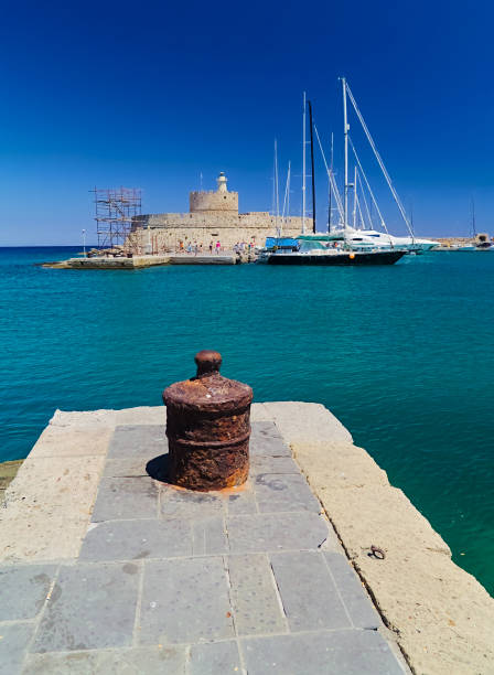 Mandraki harbor in Rhodes island, Greece. Bright summer day, deep blue sky.