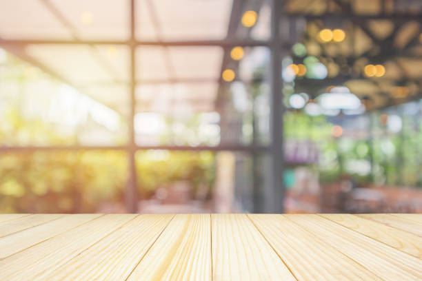 istock Empty wood table top with abstract blur coffee shop or cafe restaurant background with bokeh light for montage product display 1155930768