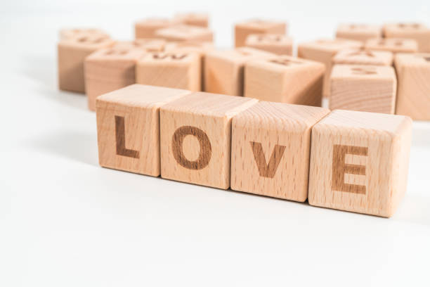 istock word LOVE on wood cube dices on white background. 1155931732