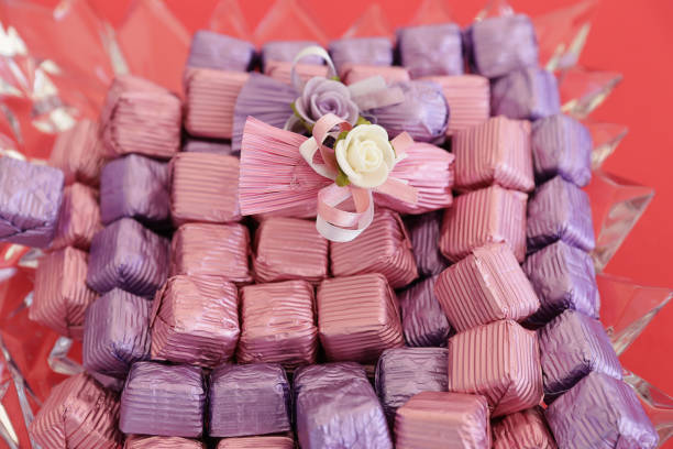 Assorted brigadeiros, traditional brazilian sweets, presented in rows on a wooden surface