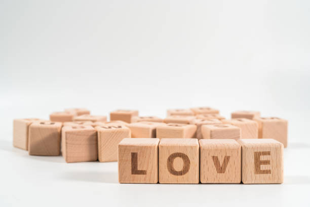istock word LOVE on wood cube dices on white background. 1155932989