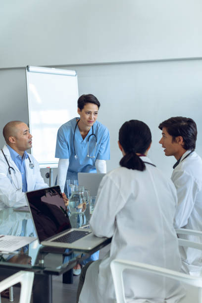 istock Medical team sitting and discussing with each other at the table 1155933279
