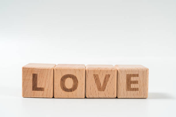 istock word LOVE on wood cube dices on white background. 1155933430