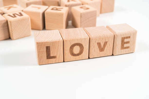 istock word LOVE on wood cube dices on white background. 1155933470