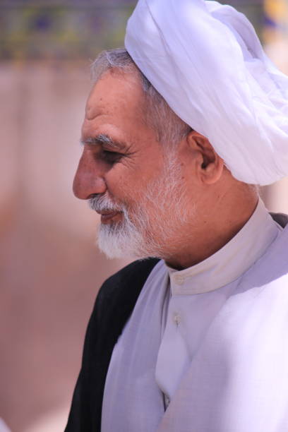 Imam with a turban, Jame Mosque, Isfahan, Iran. Isfahan, Iran - May, 2019: Imam giving quick lessons to Islam in the courtyard of Jame Mosque. mullah photos stock pictures, royalty-free photos & images