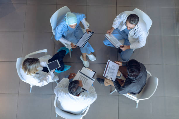 istock Medical team discussing documents with each other in hospital 1155940680