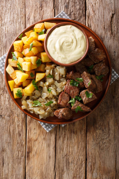 swedish beef rydberg with fried onions and crisp potatoes with mustard sauce close-up. vertical top view - main course imagens e fotografias de stock