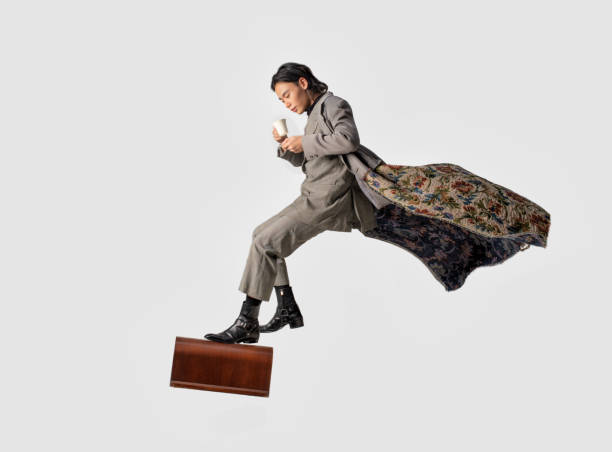 an asian chinese male step on a brief case and holding a coffee cup and plate floating in the air - men businessman jumping levitation imagens e fotografias de stock