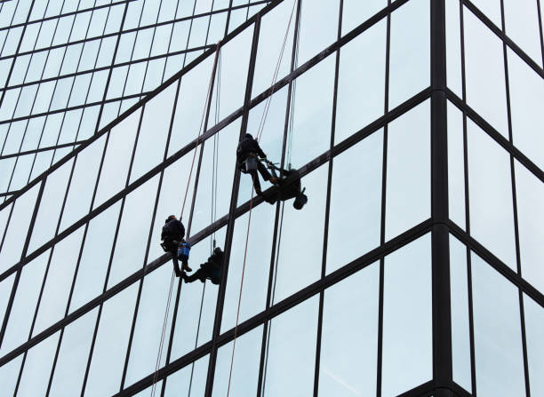 istock Window washers on the side of a city building 1155943083