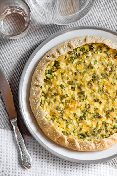 istock Tart with eggs and green onions on a plate 1155943227