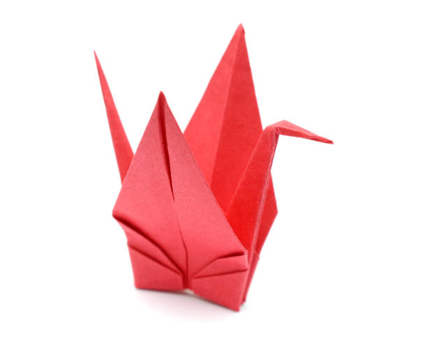 istock A red origami paper bird on paper background 1155943258