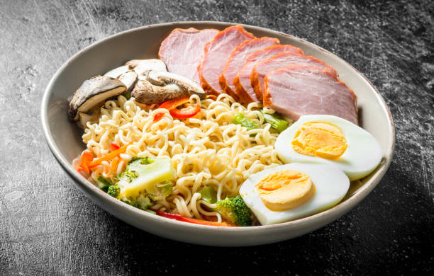 istock Instant noodles in bowl with broccoli, mushrooms, becon and egg. 1155944761