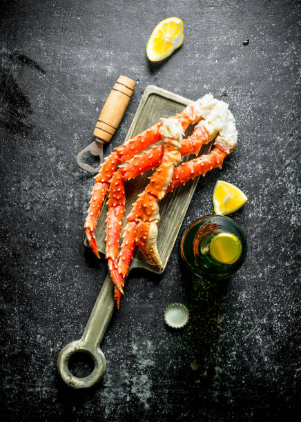 istock Crab on a cutting Board with beer and lemon slices. 1155945220