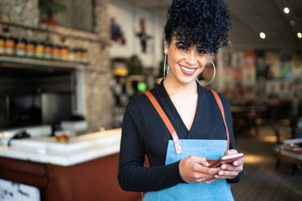 istock Portrait of business owner using phone and looking at camera 1155945266